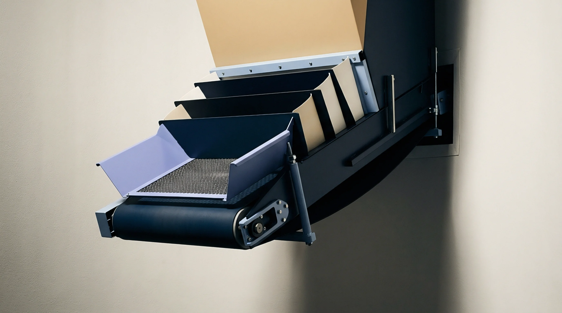 An illustration features an automated conveyor assembly with multiple dividers and a metal mesh tray positioned within an industrial processing unit.
