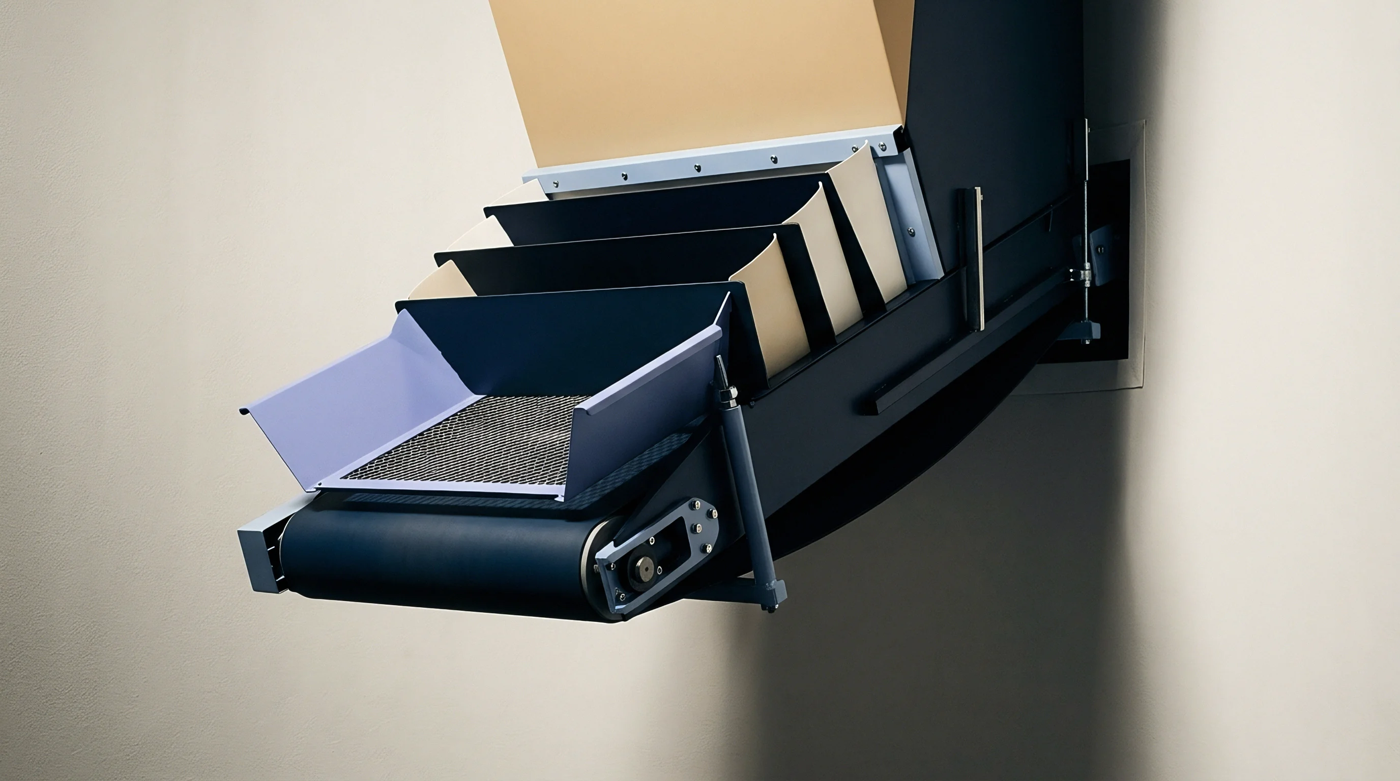 An illustration features an automated conveyor assembly with multiple dividers and a metal mesh tray positioned within an industrial processing unit.